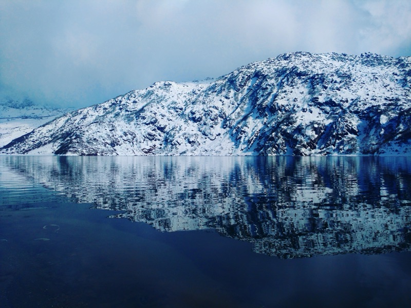 Tsomgo Lake in Sikkim surrounded by snow-covered mountains